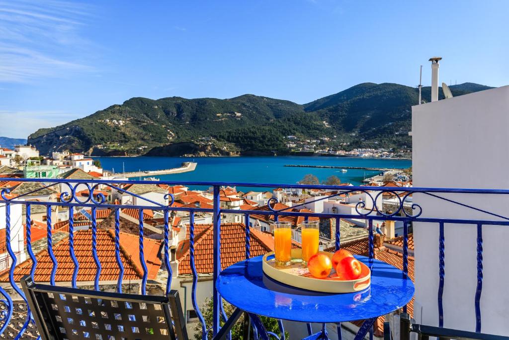 a bowl of fruit on a table on a balcony at SUN NEST HOUSE in Skopelos Town