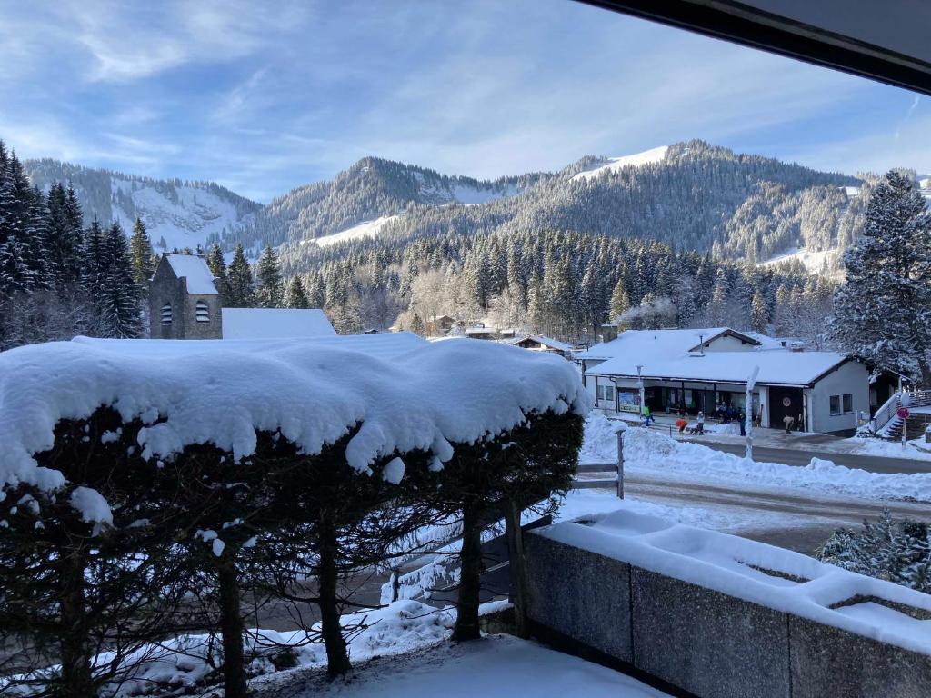 a view of a snow covered mountain from a house at Ferienwohnung Jagdhof Spitzingsee in Schliersee
