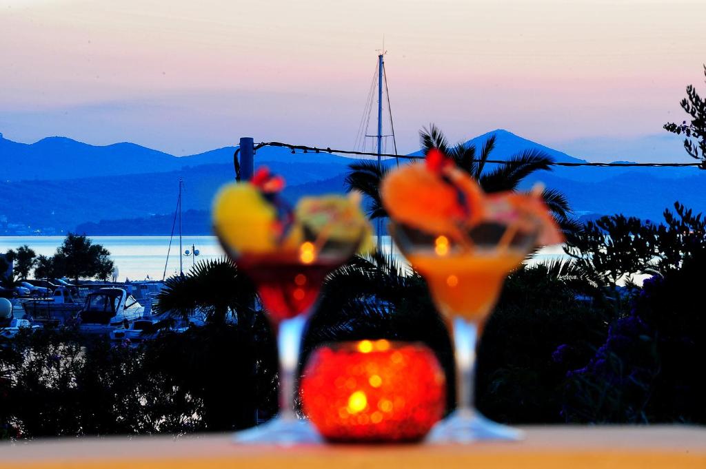 two glasses with fruit in them sitting on a table at Apartments Ka - Ro in Bibinje