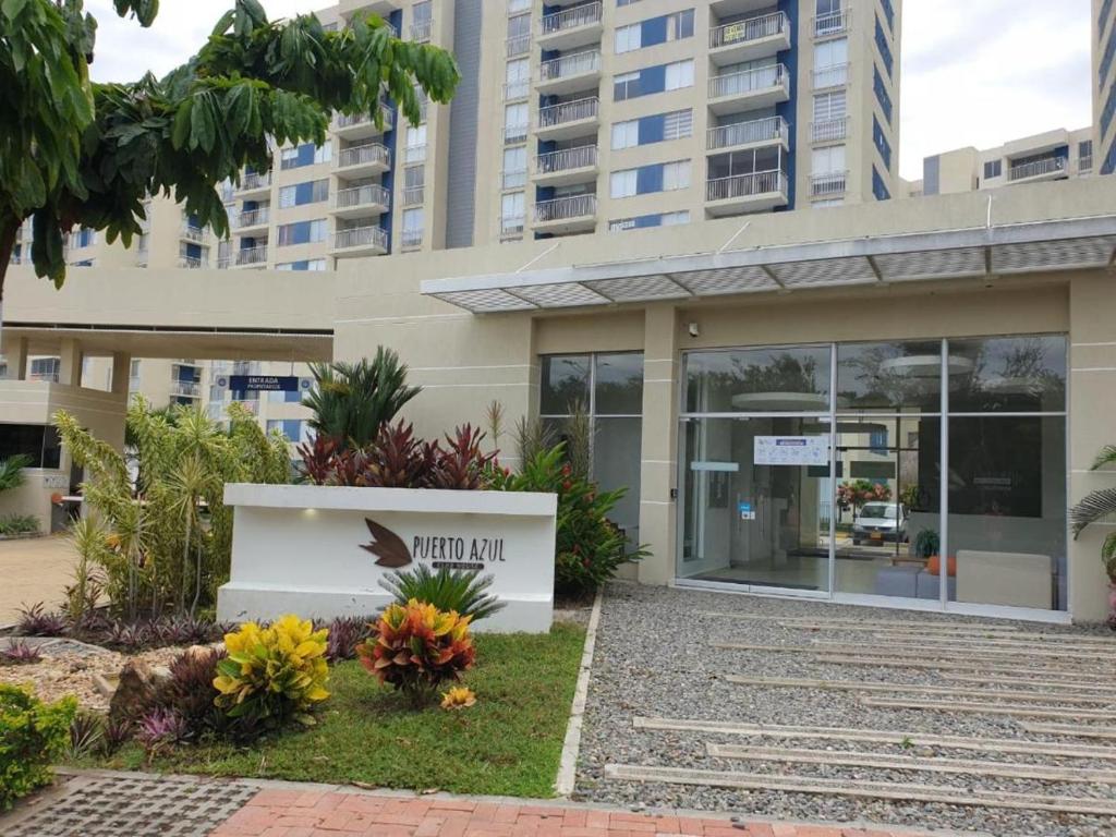 a building with a sign in front of it at Apartamento en Ricaurte conjunto Puerto Azul Club House in Ricaurte