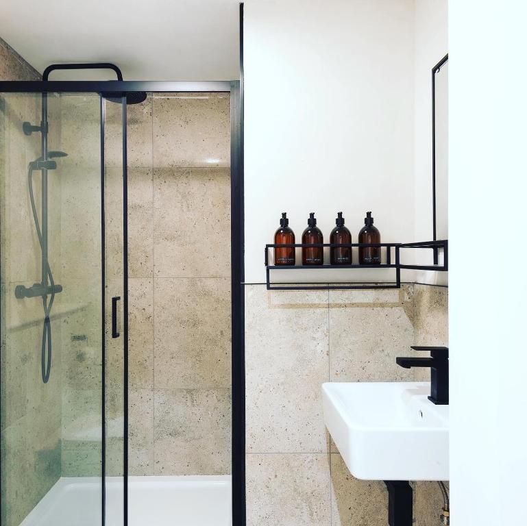 a bathroom with a shower and a sink at CoalShed in Bristol