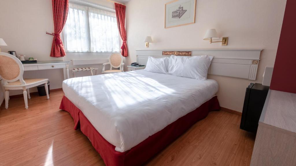Postel nebo postele na pokoji v ubytování Hotel des Horlogers