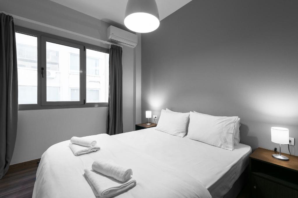 Łóżko lub łóżka w pokoju w obiekcie Aelia Apartments, The Luxury Suites