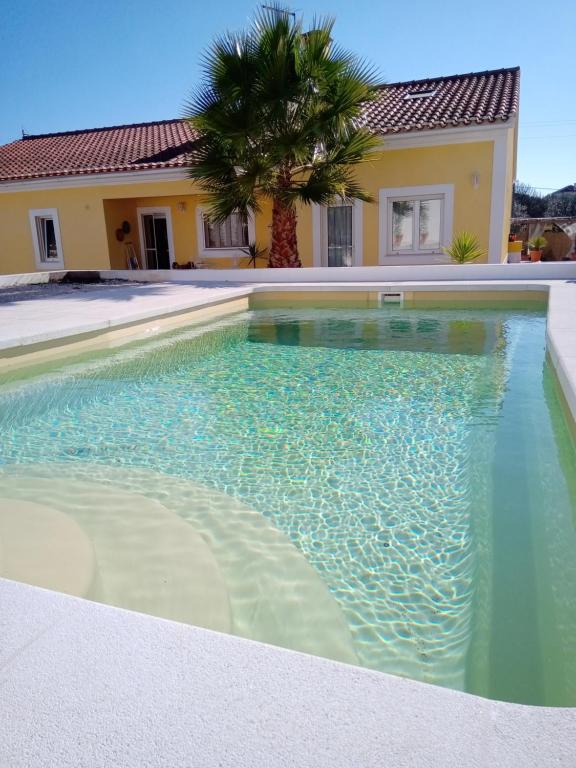 a swimming pool in front of a house at Monte das Pedras in Abrantes
