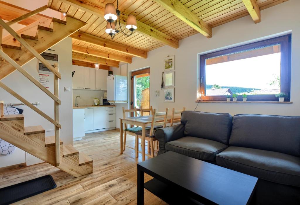 a living room with a couch and a table at Bieszczadzki Jeleń in Ustrzyki Dolne