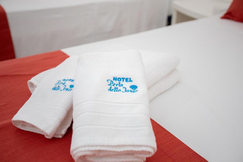 Postel nebo postele na pokoji v ubytování Hotel Perla Dello Ionio