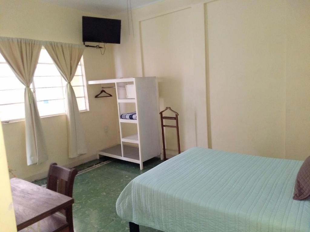 Postel nebo postele na pokoji v ubytování Hotel Suites Córdoba