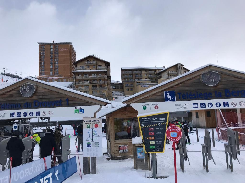 un lodge de ski avec des personnes debout à l'extérieur dans la neige dans l'établissement Appartement 6 personnes - Deux chambres - 40M2 - Balcons 10M2 sur pistes - Aucun vis à vis - Piscine - B301, à Orcières