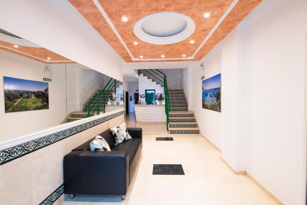 a living room filled with furniture and a stair case at Hotel Apartamentos Villa Gomera in San Sebastián de la Gomera