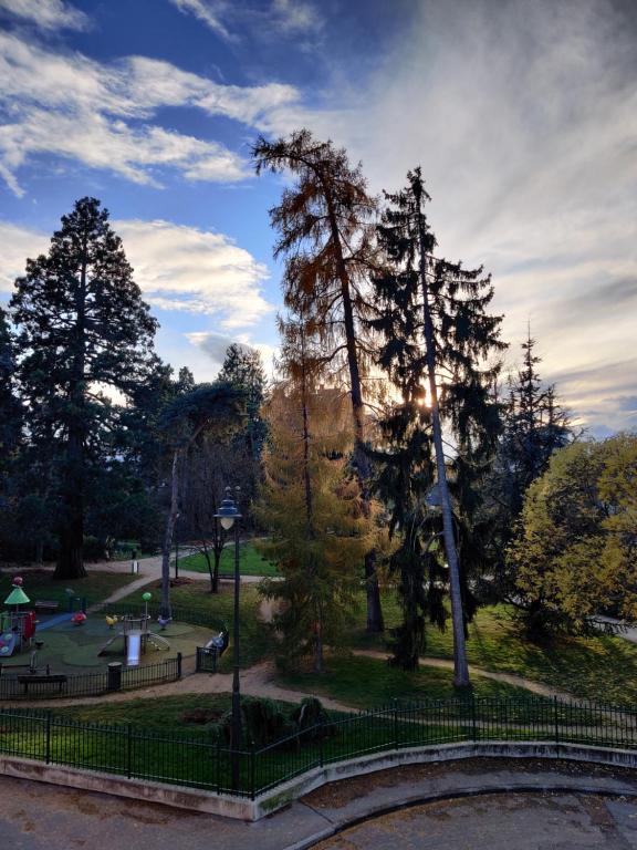 a park with a fence and a park with trees at Appartement du parc des thermes in Thonon-les-Bains
