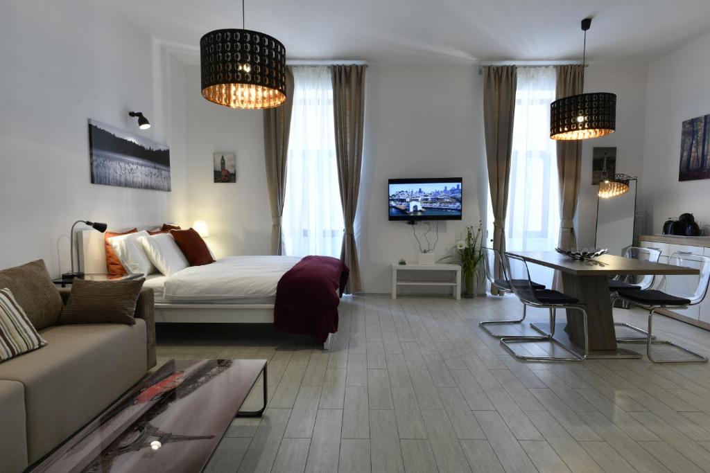a bedroom with a bed and a couch and a table at Apartment Antiope in Zagreb