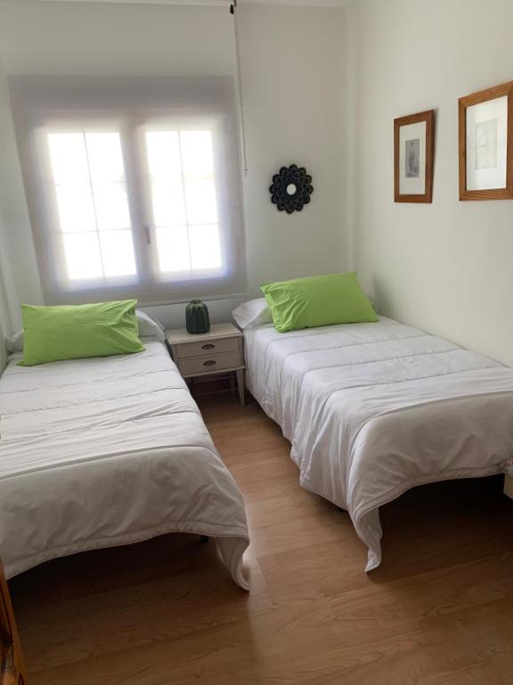 Cama o camas de una habitación en El balcón de Araceli