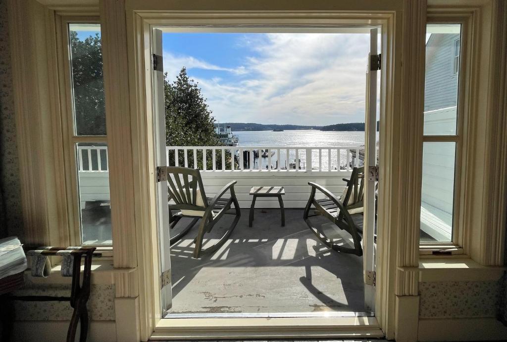 a door to a porch with a view of the water at Orcas Hotel in Orcas