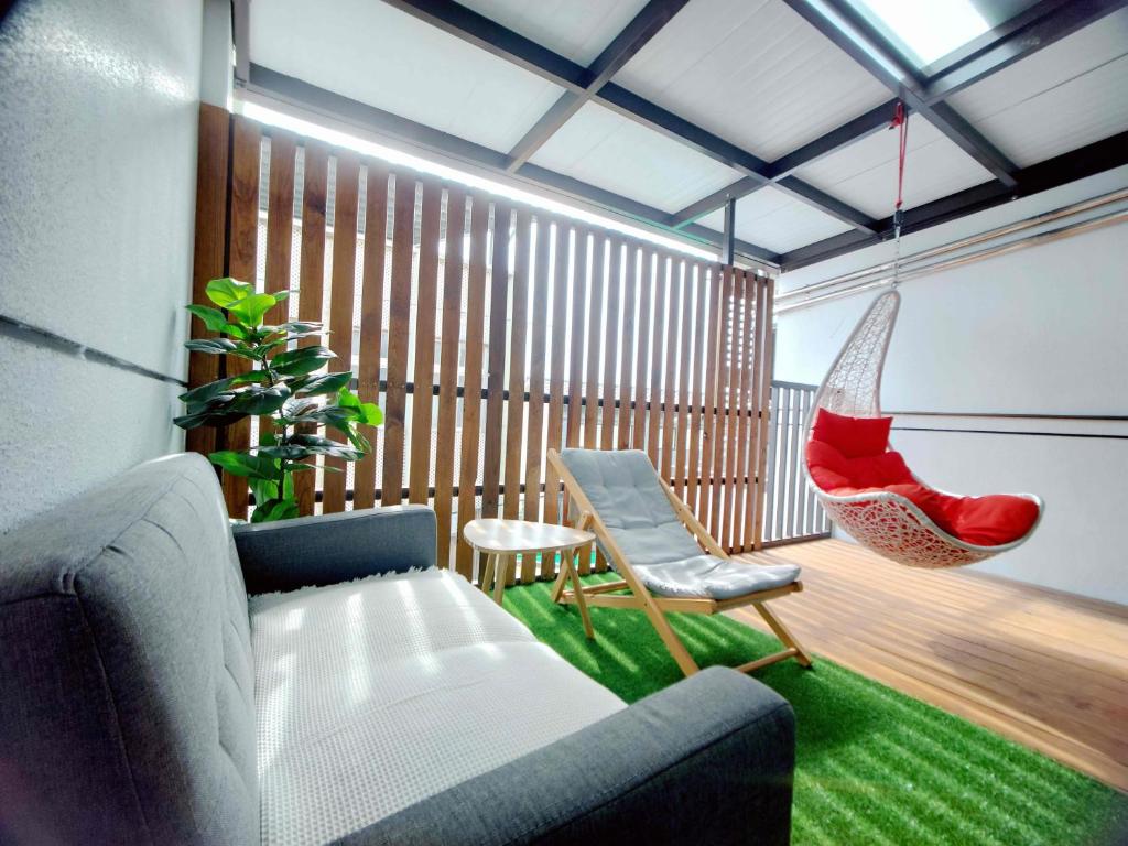 a living room with a couch and a hammock at Field Trail Homestay in Jiaoxi