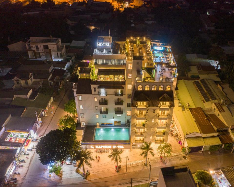 a building with a pool in the middle of a city at night at Hapyson in Long Khanh