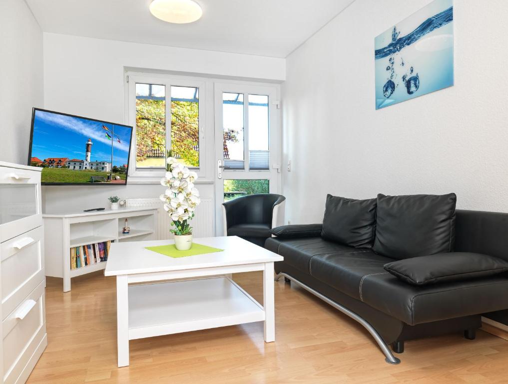 a living room with a couch and a table at Haus Seeblick Steuerbord in Insel Poel