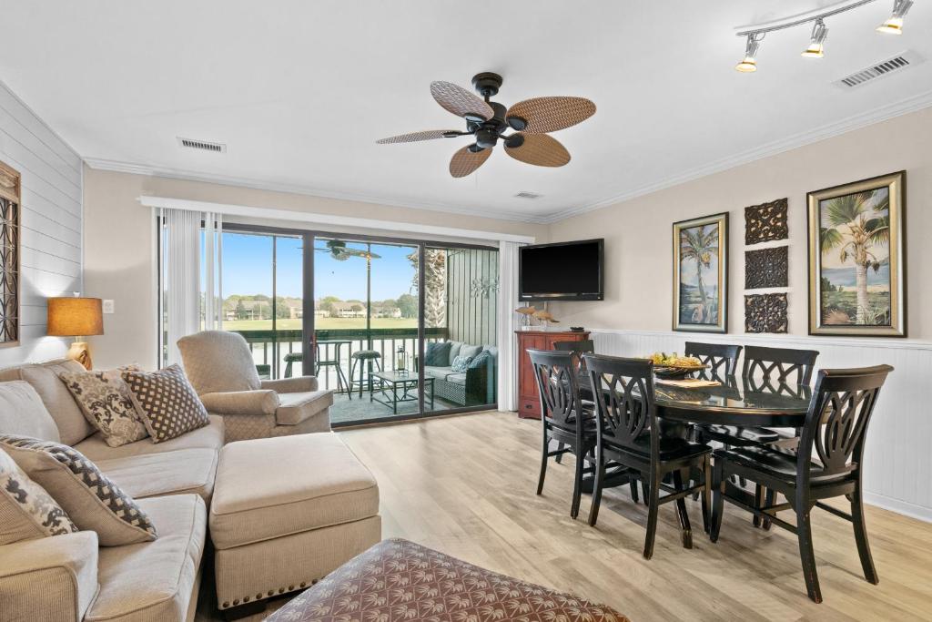 a living room with a couch and a table at Seascape Lakefront Villas 232 in Destin
