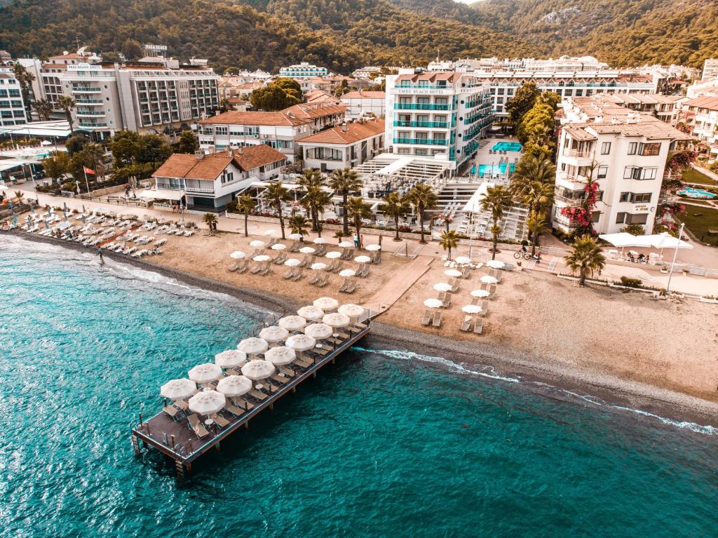 an aerial view of a beach with umbrellas and a pier at Emre Beach & Emre Hotel in Marmaris