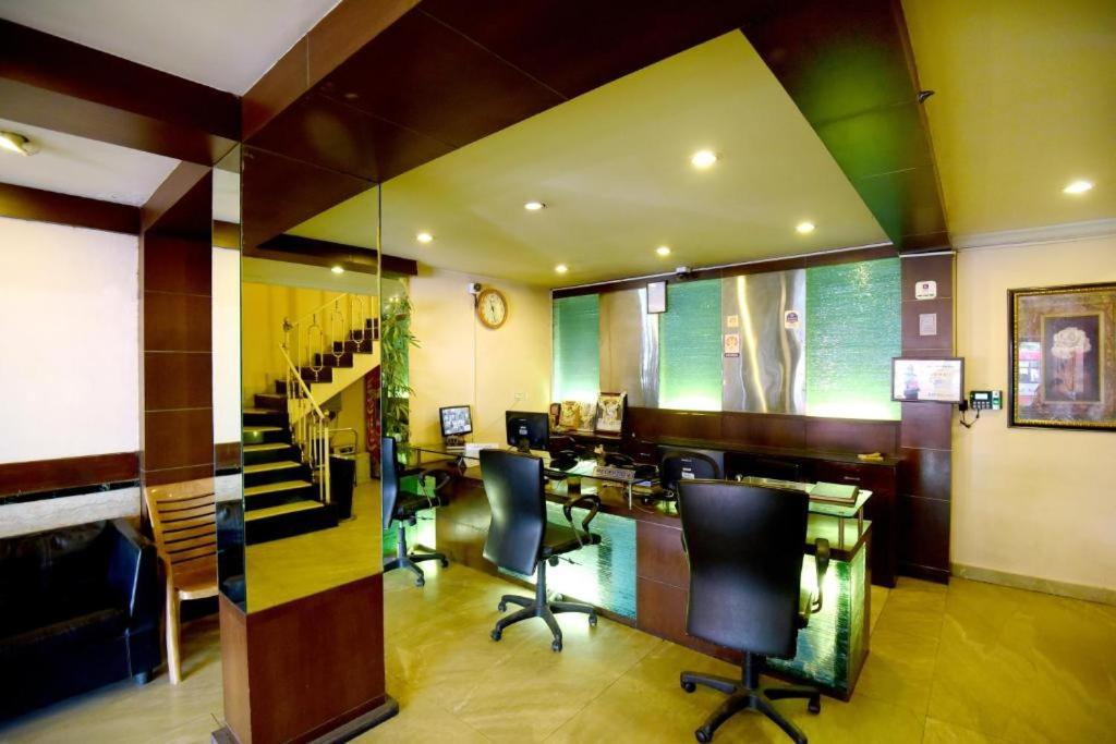 a bar with chairs and tables in a room at Shastri Paradise opst to KSRTC Bus Stand in Mysore