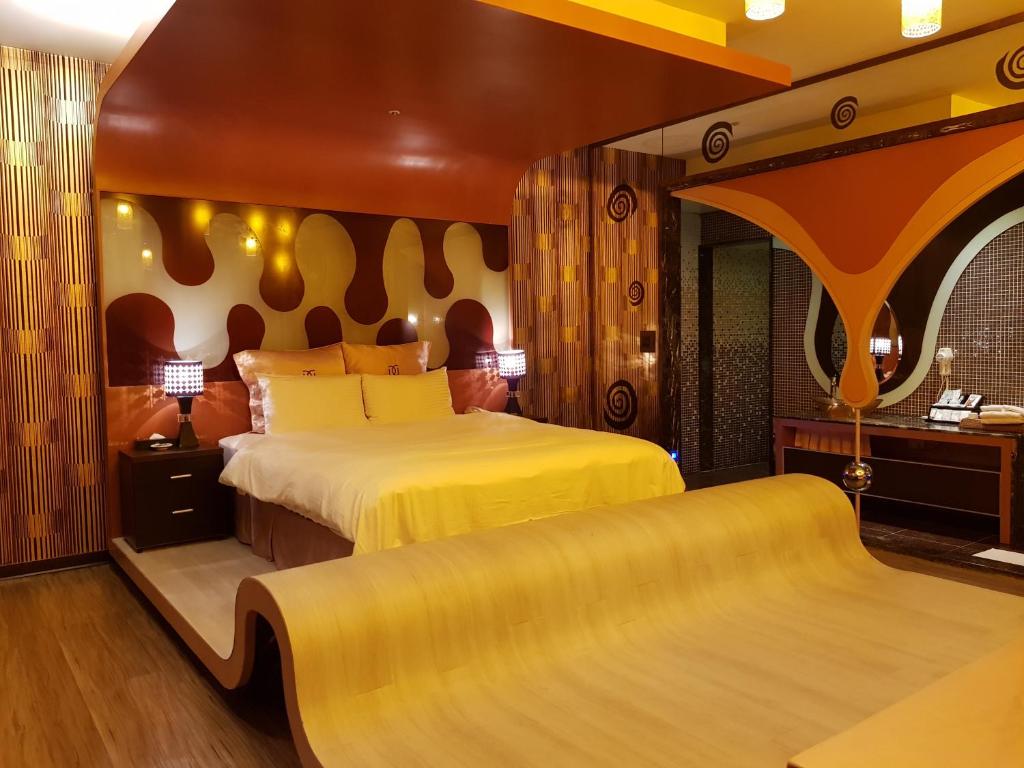Postel nebo postele na pokoji v ubytování Discovery Motel - Zhonghe
