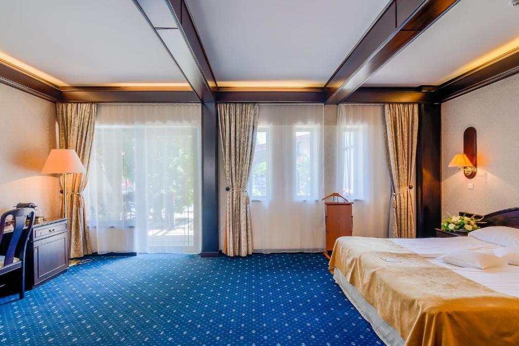 Postel nebo postele na pokoji v ubytování Hotel Snagov Club