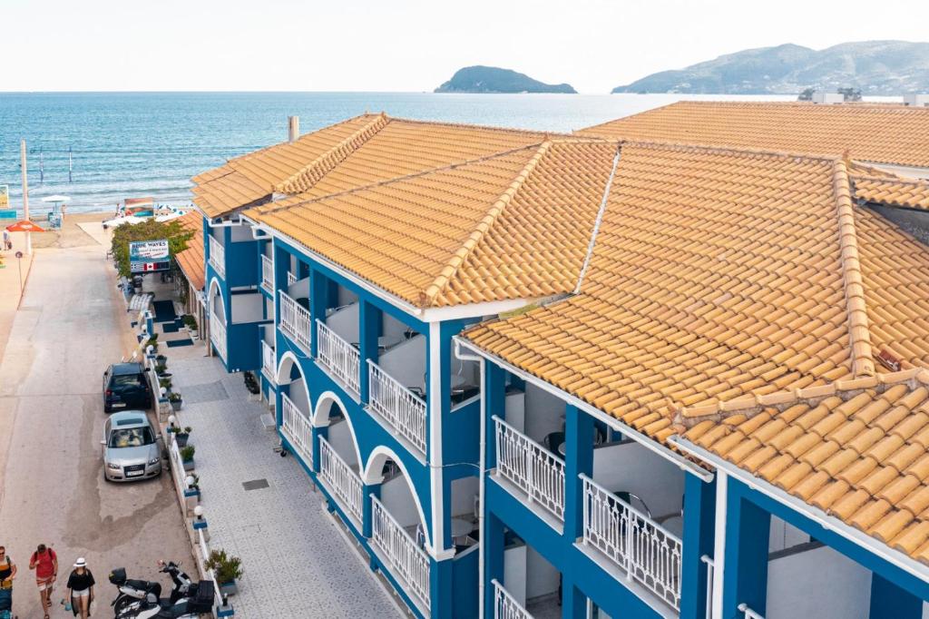 a view of a blue building with the ocean in the background at BLUEWAVES in Laganas