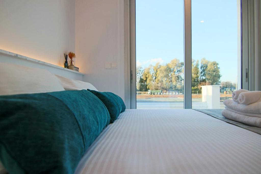 a bedroom with a bed with a large window at Phaedrus Living - Seaside Deluxe Flat Harbour 106 in Paphos