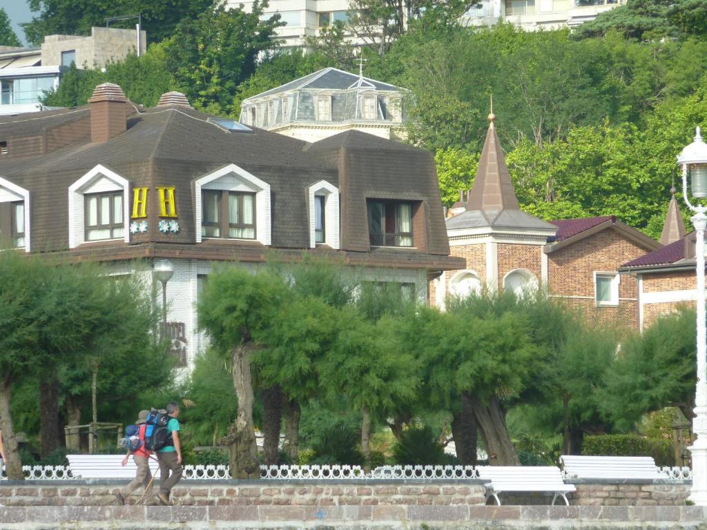 a man walking in front of a house at Hotel Ezeiza in Donostia-San Sebastián