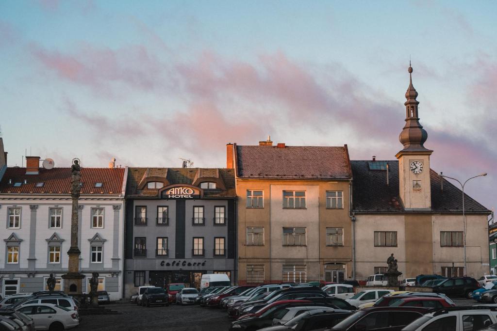 a city with cars parked in a parking lot at Hotel Amco in Zábřeh