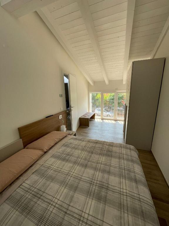 a large bed in a room with a large rug on the floor at LOCANDA LA CAMPAGNOLA orari check in dalle 1130 alle 1530 e dalle 1830 alle 2330 in Vignola