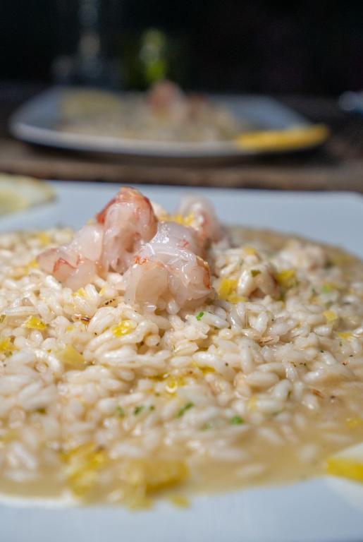 a plate of rice with shrimp on top of it at Agriturismo Buranco in Monterosso al Mare