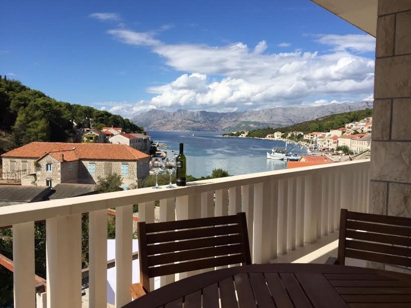 a balcony with a view of a body of water at Apartment in Povlja with sea view, terrace, air conditioning, WiFi 3419-1 in Povlja