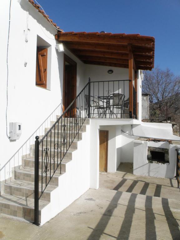 a house with stairs and a balcony at Dream House in Theológos