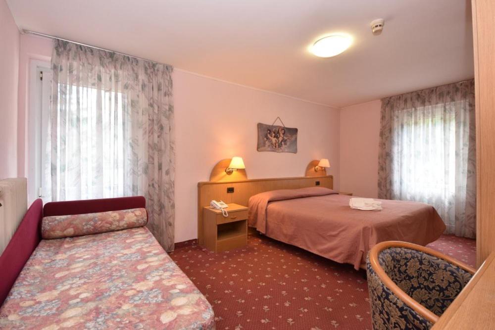 Postel nebo postele na pokoji v ubytování Hotel Villa Agomer