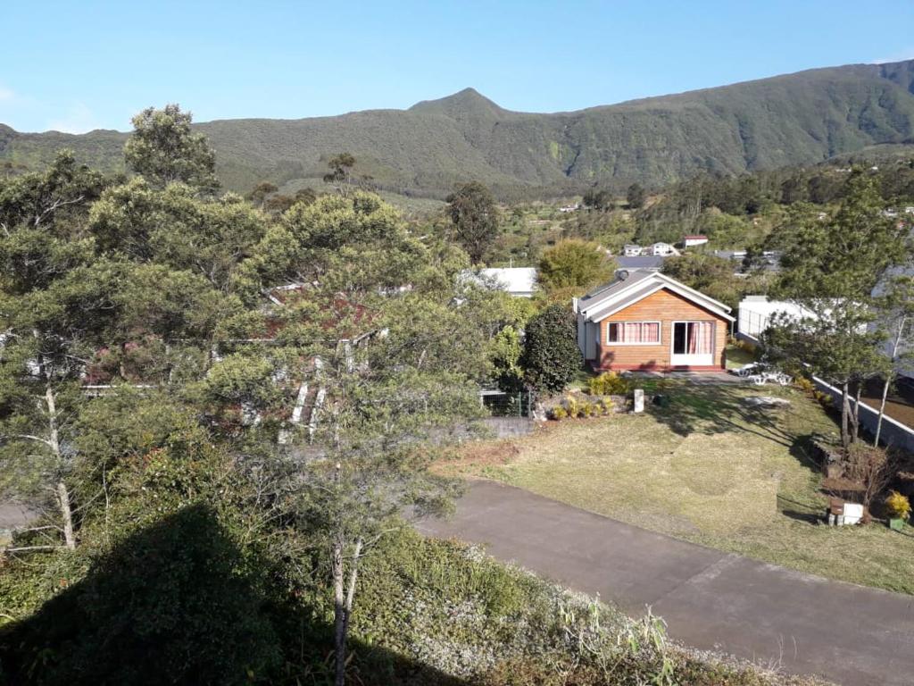 an aerial view of a house with mountains in the background at Villa Camélias in La Plaine des Palmistes