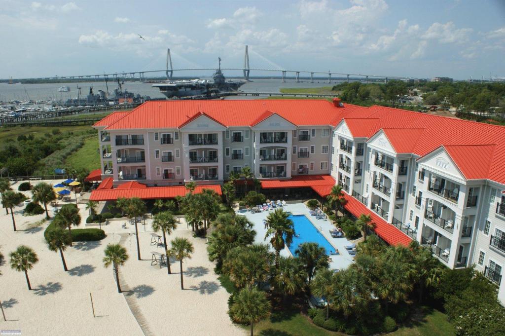 an aerial view of a resort with a pool and palm trees at Harborside at Charleston Harbor Resort and Marina in Charleston