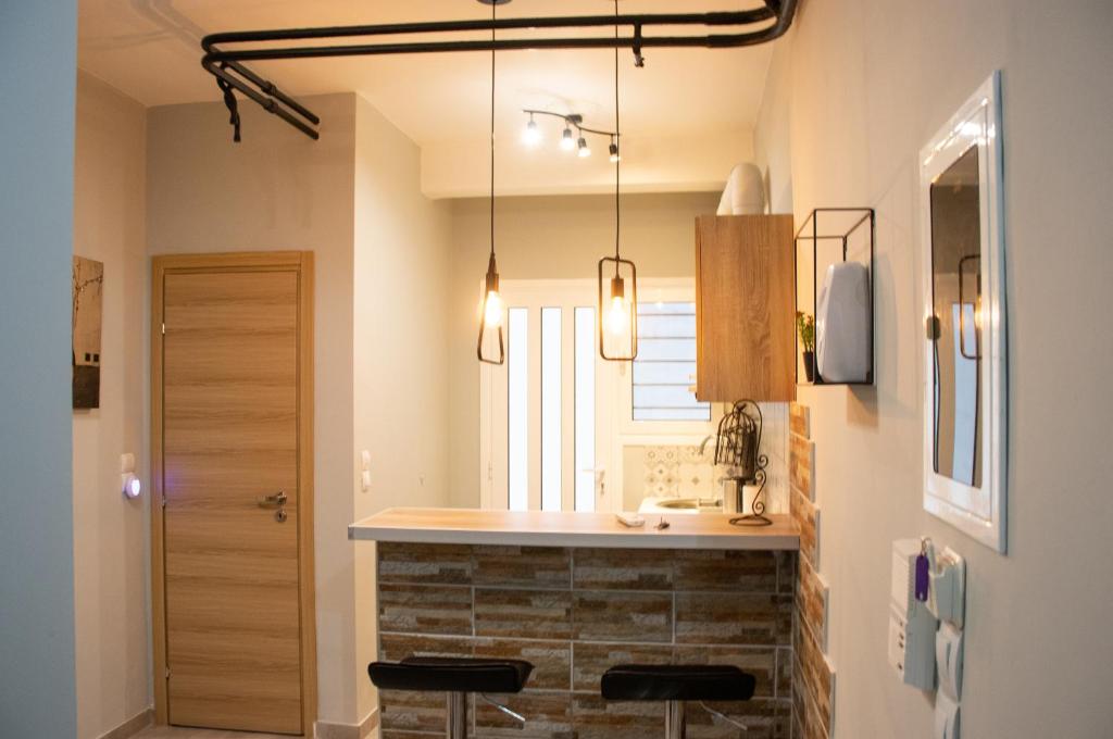 uma cozinha com um balcão e um lavatório num quarto em Cozy LOFT Κypseli with a yard em Atenas