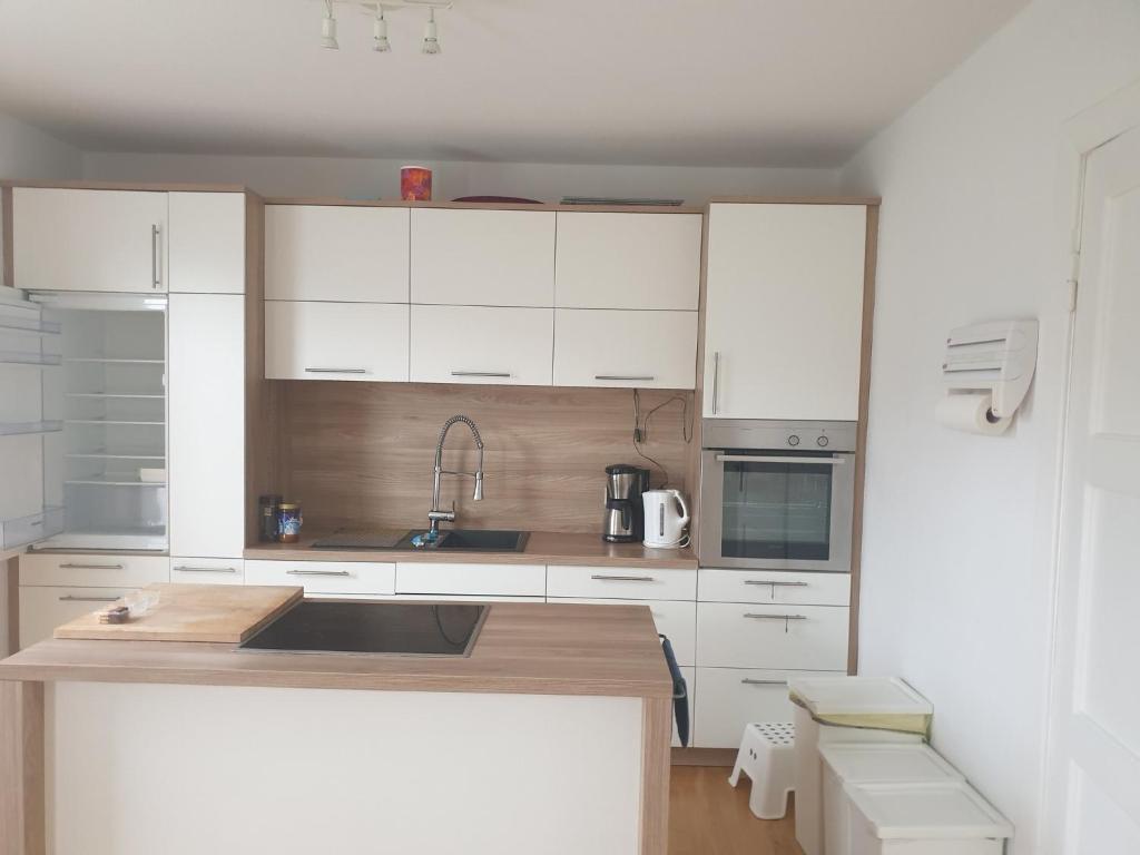 a kitchen with white cabinets and a counter top at Ferienhaus 3119 in Tossens in Butjadingen OT Tossens