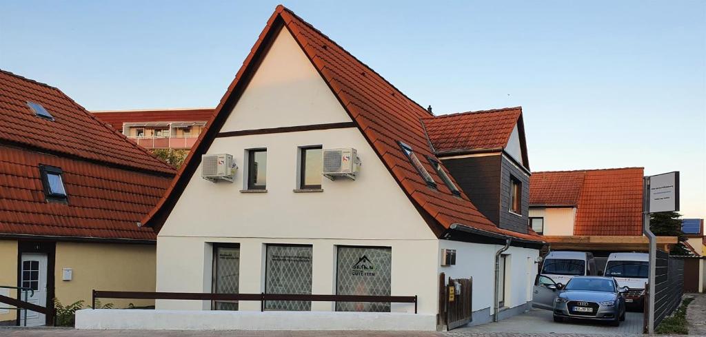 a white house with a brown roof at Gäste und Geschäftswohnung Stolle in Bad Dürrenberg