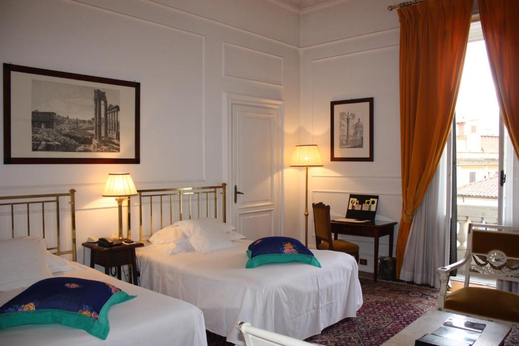 Postel nebo postele na pokoji v ubytování Grand Hotel Plaza