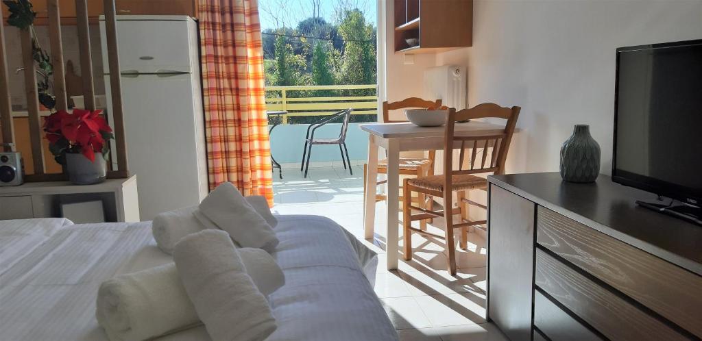 a living room with a bed and a television at Παλατάκι in Patra
