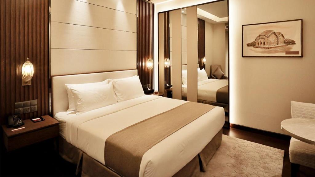 Kama o mga kama sa kuwarto sa Best Western PLUS Maya - Luxury Collection Hotel