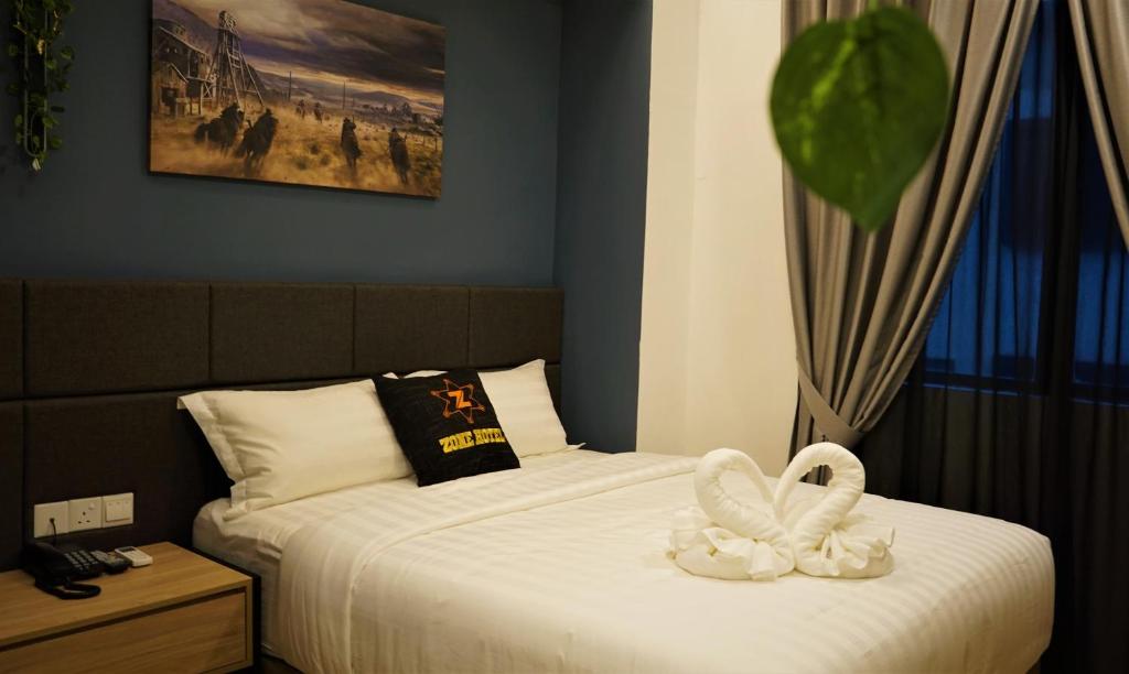 Postel nebo postele na pokoji v ubytování Zone Hotel Ipoh