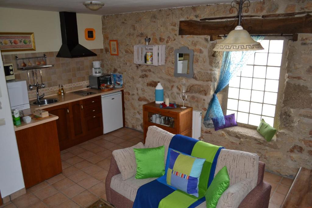 a living room with a couch and a kitchen at La Fuente in Umbrías