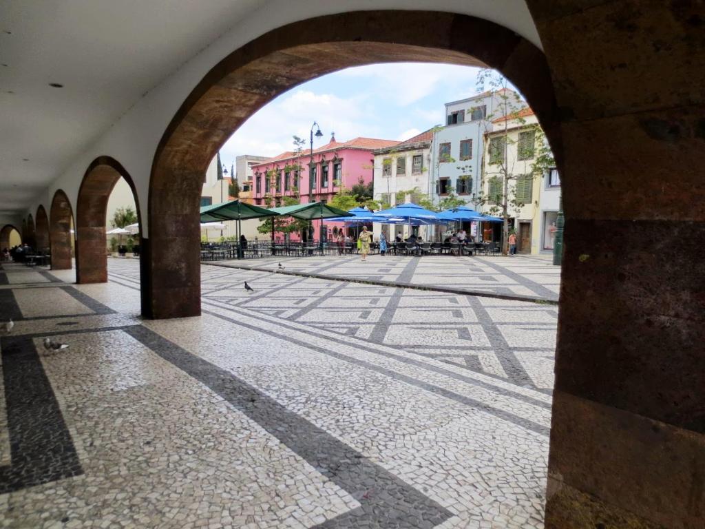 an empty street in a city with an archway at Funchal Downtown by ALMA Holiday Rentals in Funchal