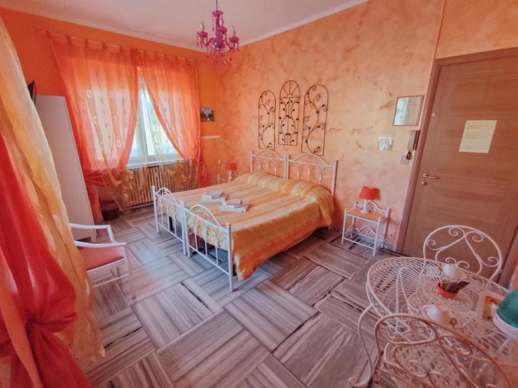 a bedroom with a bed and a table in it at Hotel Serenella in Turin