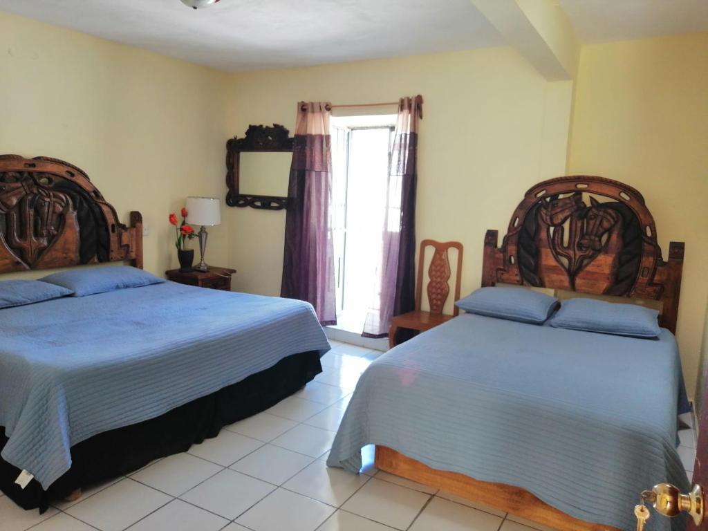 Postel nebo postele na pokoji v ubytování Hotel Chely