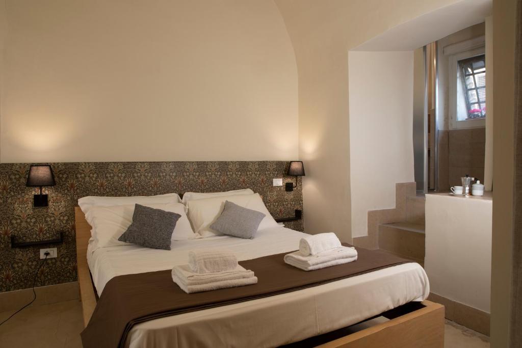 a bedroom with a large bed with towels on it at Casa Ferretti in Iesi