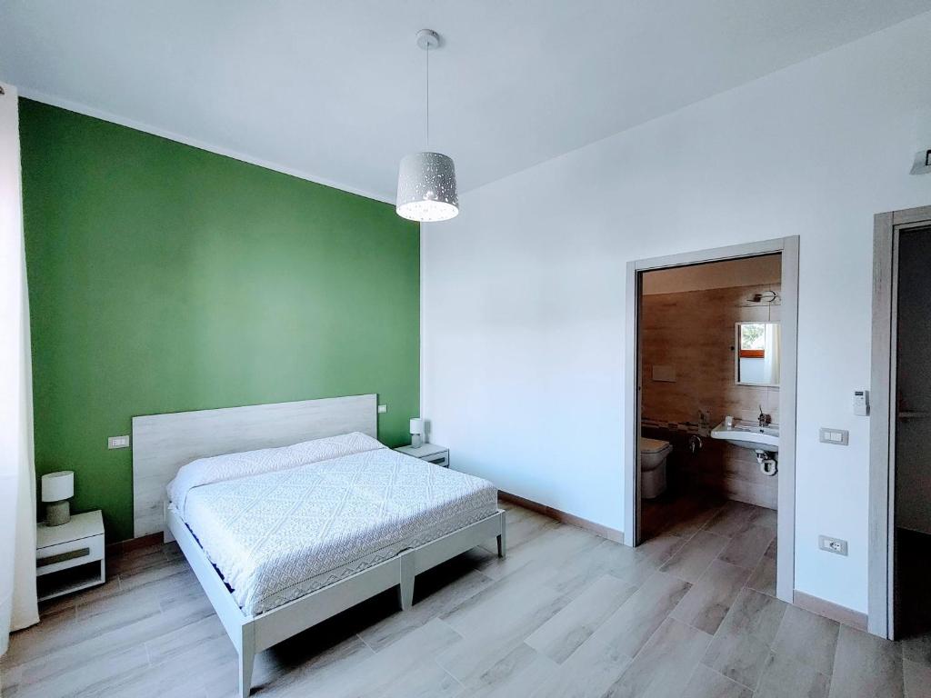 A bed or beds in a room at Sa Banita affittacamere