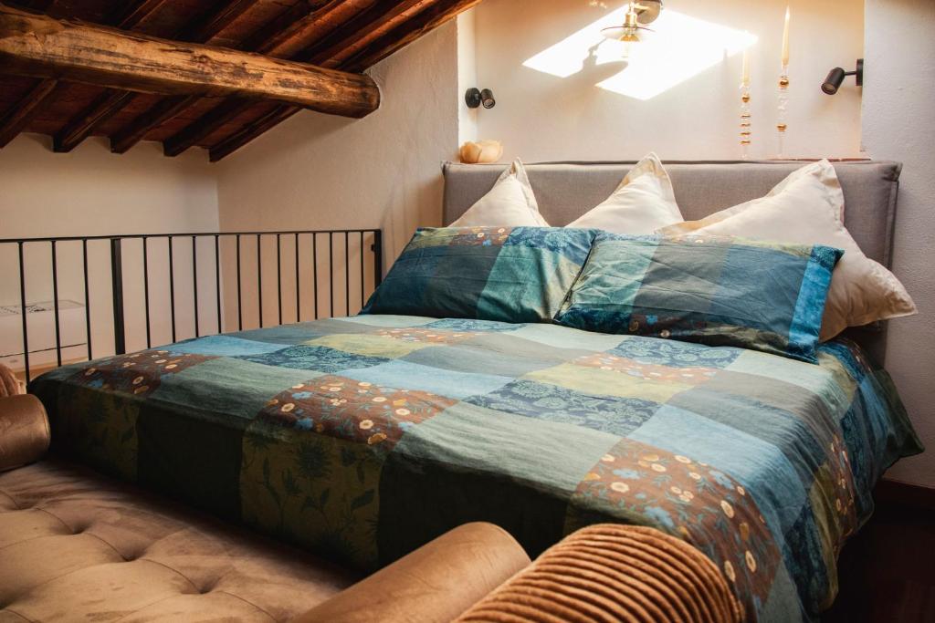 a bedroom with a bed with a quilt on it at La Torre in Torrita di Siena